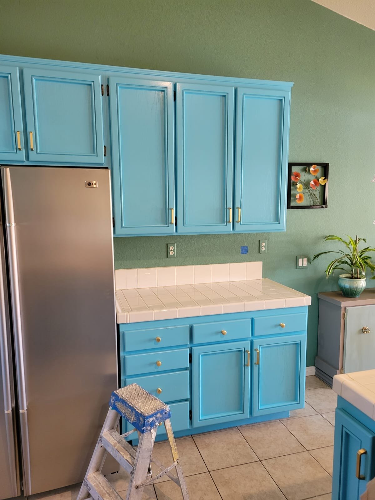 Carefully prepared and refinished blue kitchen cabinets
