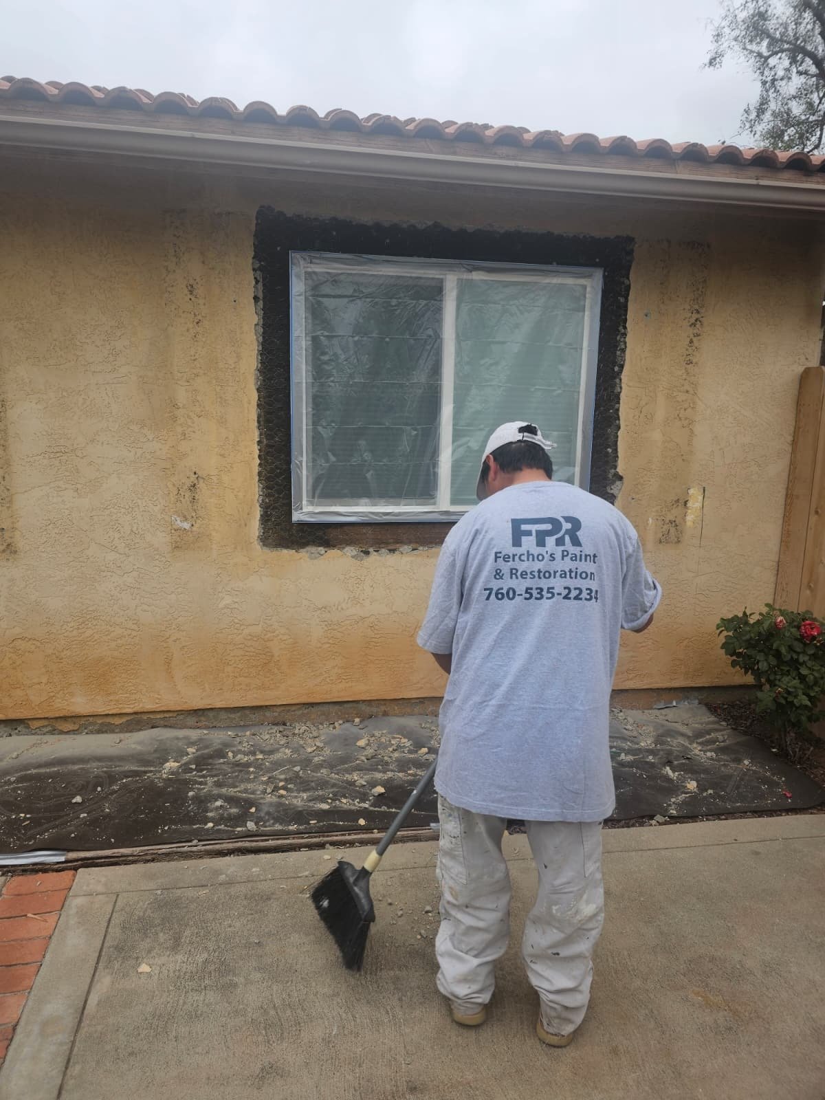 Fercho's crew preparing an exterior wall for restoration